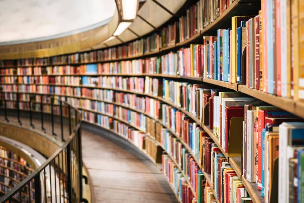 books on brown wooden shelf in a library