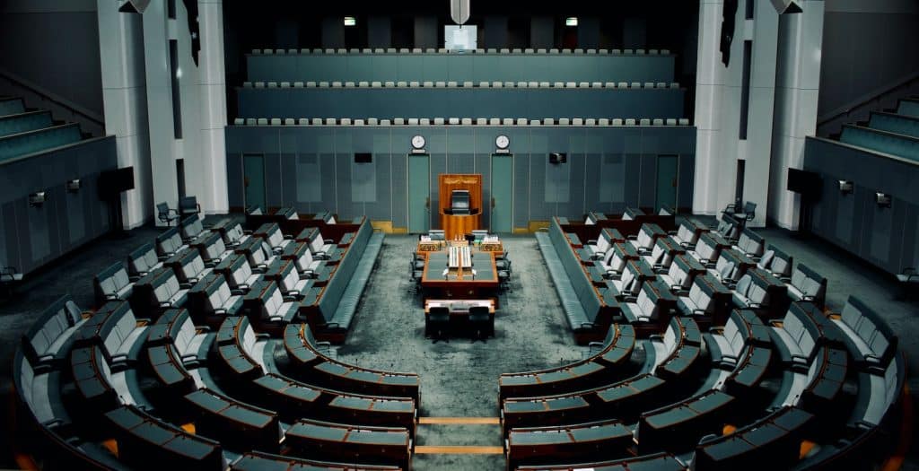 tables and chairs inside the hall for politics